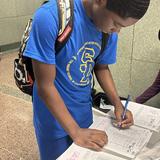 Middle School 35 Stephen Decatur Photo #3 - Student signing in for morning arrival.